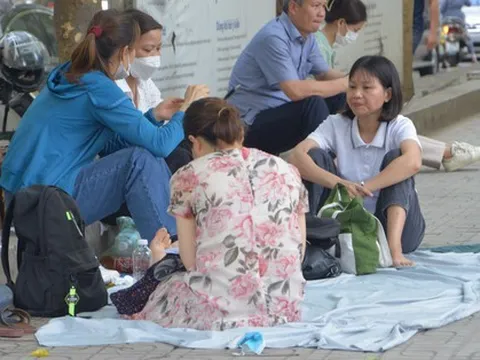 Nỗi lòng cha mẹ ngày con thi vào lớp 10: Phơi mình giữa nắng gần 40 độ, rải áo mưa xuống nền đất nóng đợi tin con
